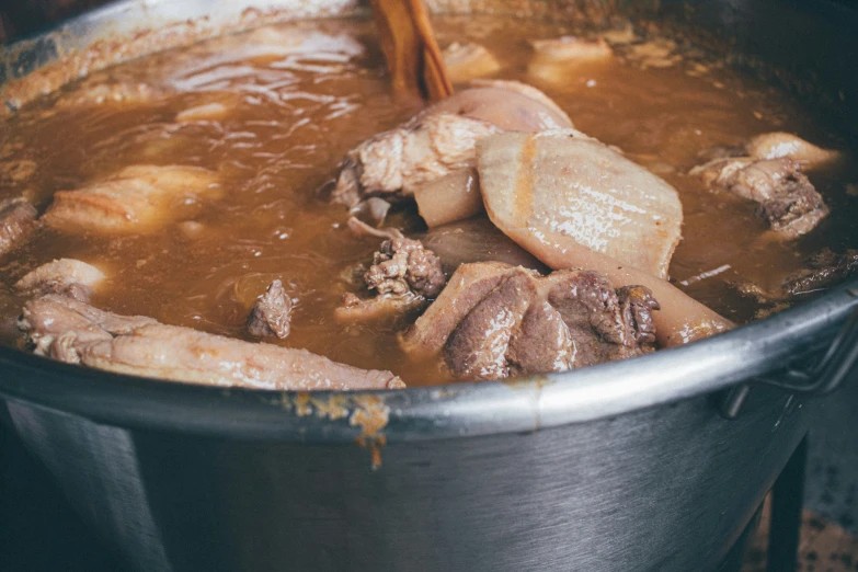 some soup is mixed in with meat in a pot