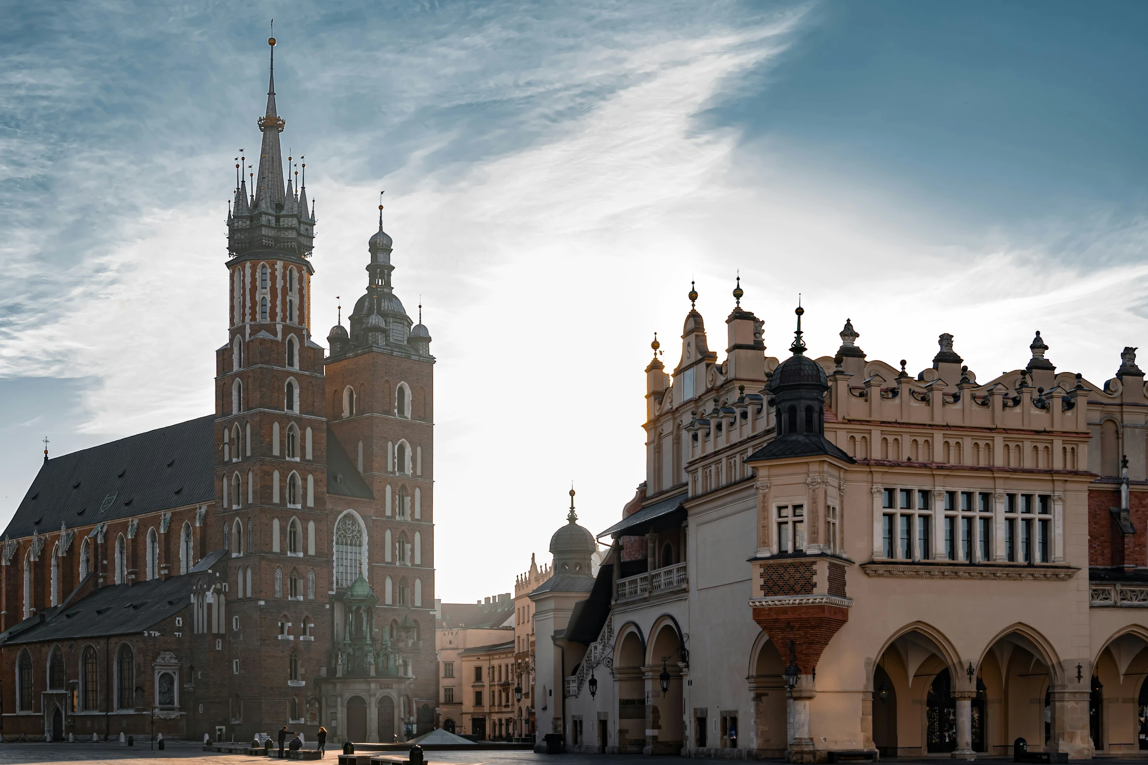 an old building with the clock tower of an older church