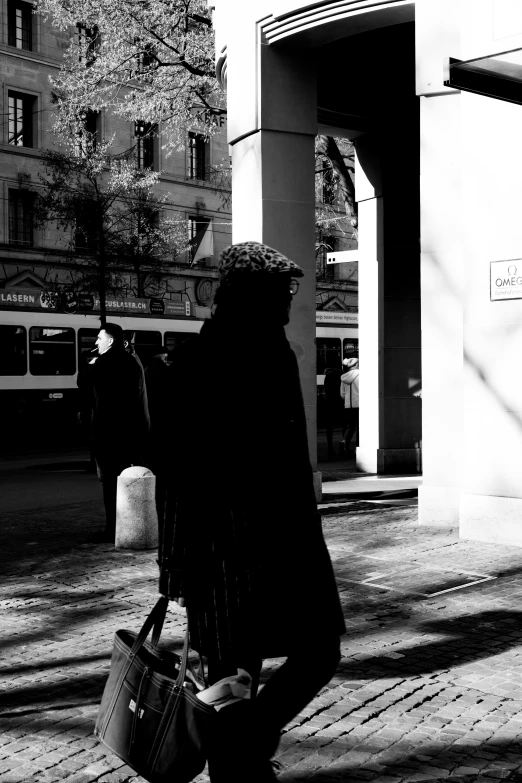 a person with a bag walks down a street