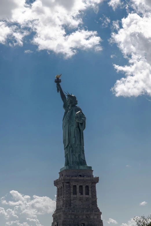 a view of a statue of liberty from ground level