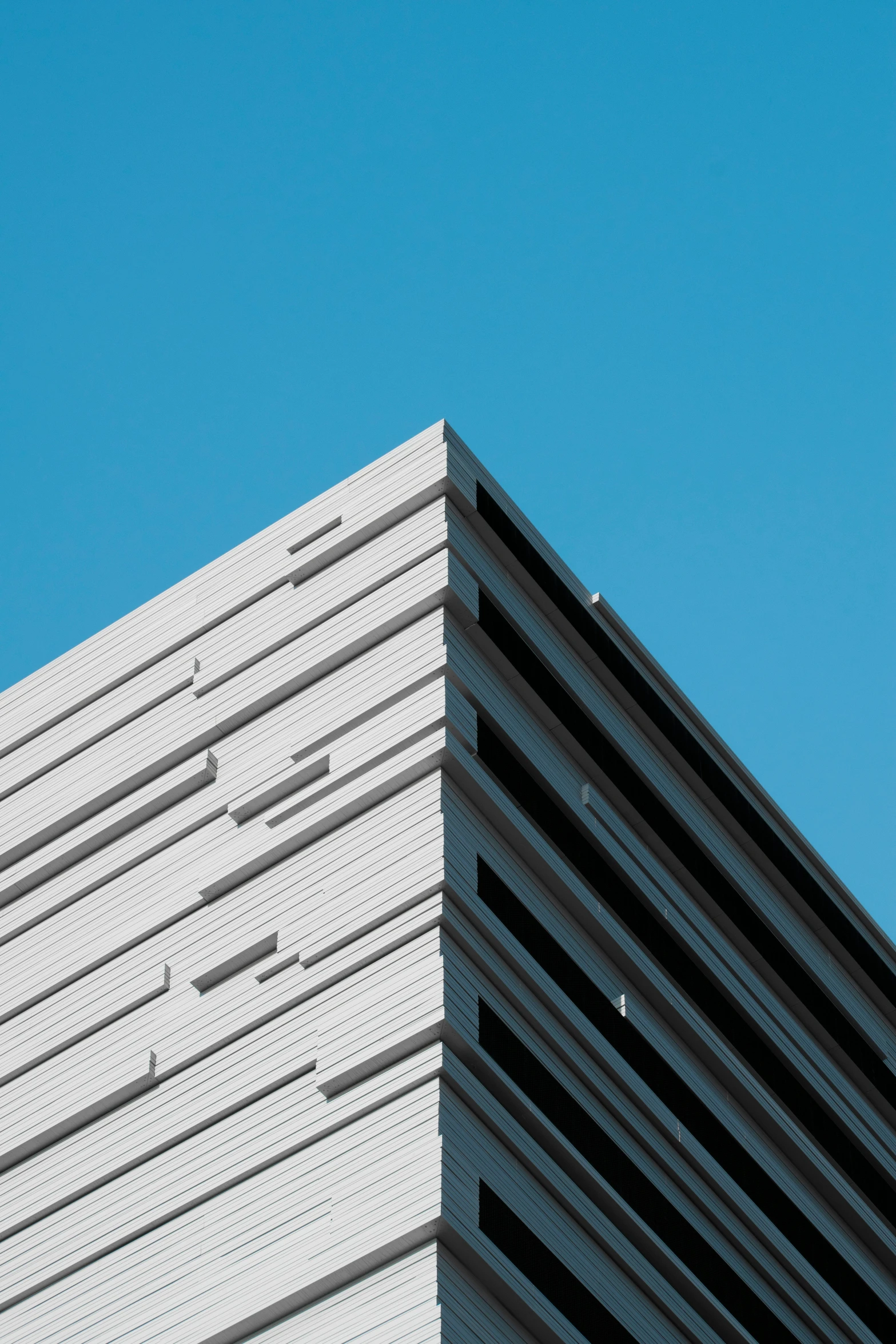 a clock on a building with a clear blue sky behind