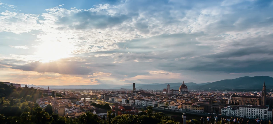 the sun sets over a very big city