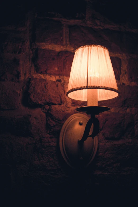 a lit lamp sitting on top of a wall