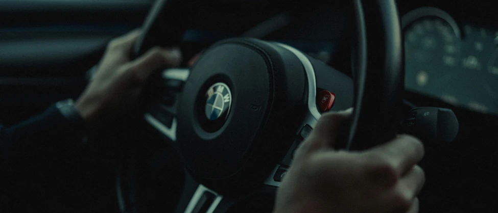 a hand is holding the steering wheel of a car