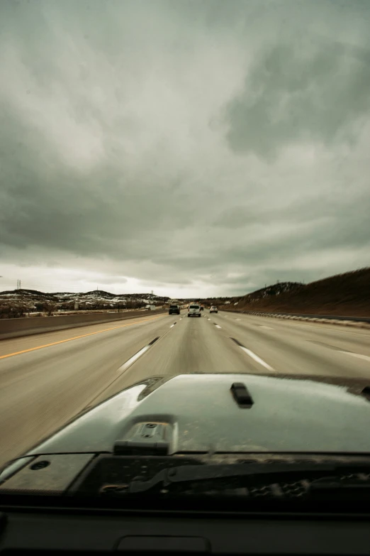 a view out a car window at cars driving down the road