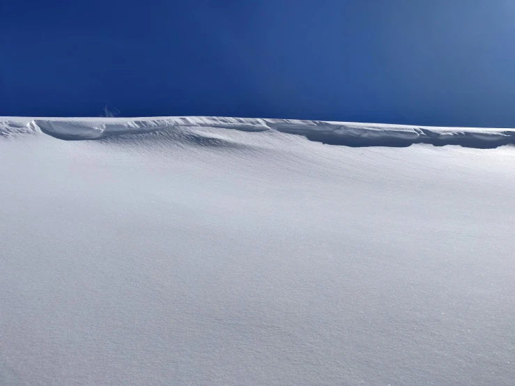 a person riding skis on top of snow covered ground