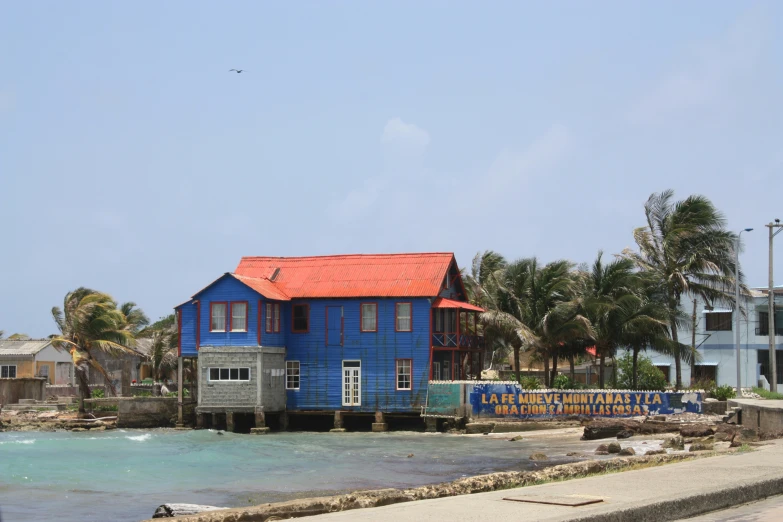 an image of a blue building on the side of the road