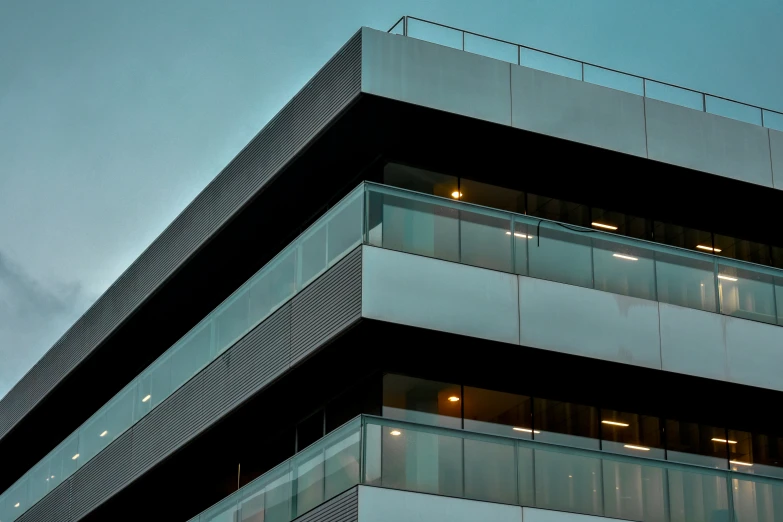 the side of an office building has windows that are lit up