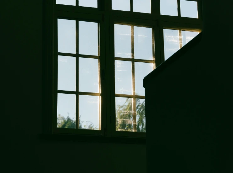 the sunlight shines in through a window onto a staircase