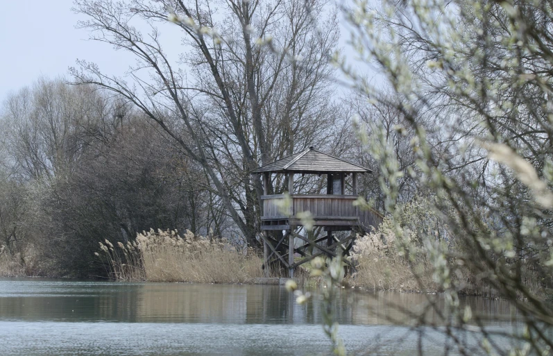 water way with trees and a small building