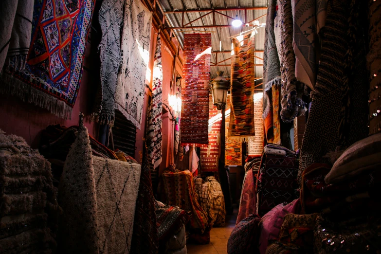 an interior of a tent or store with carpet and rugs