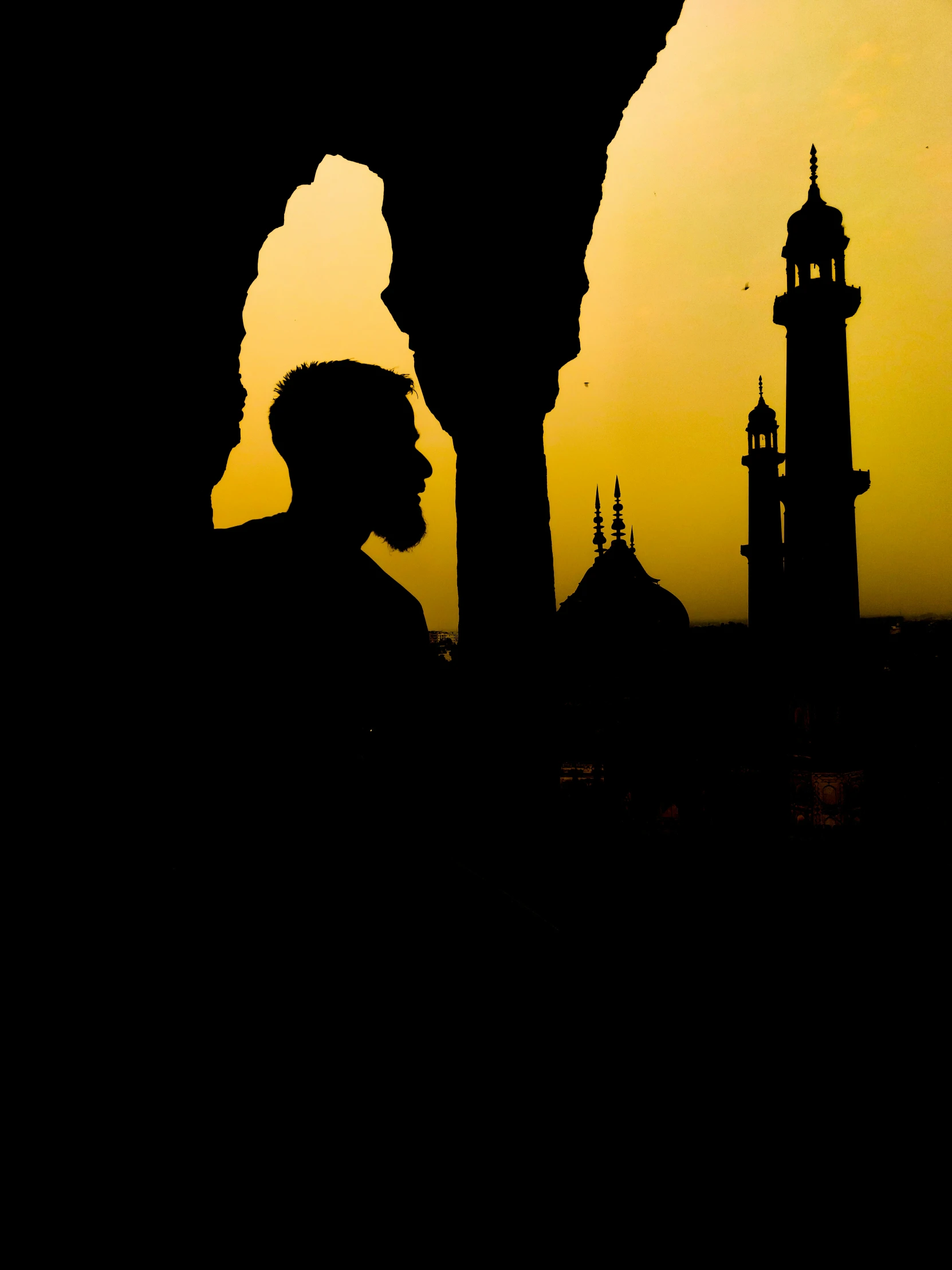 silhouette pograph of man and a building in background