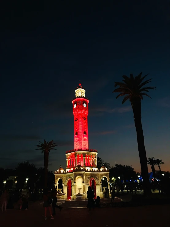 a tower with lights is at night lit up