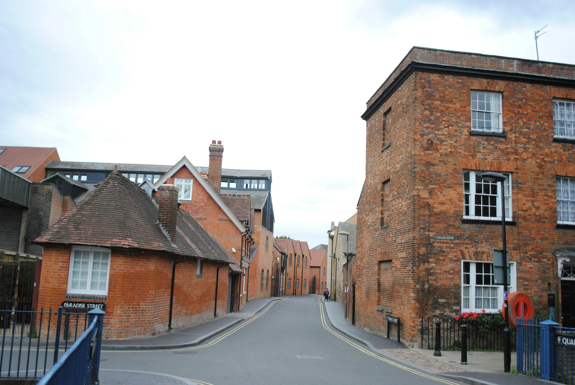 small alley between two buildings next to a road