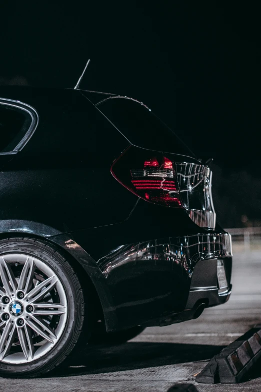 a silver and black bmw parked in a parking lot