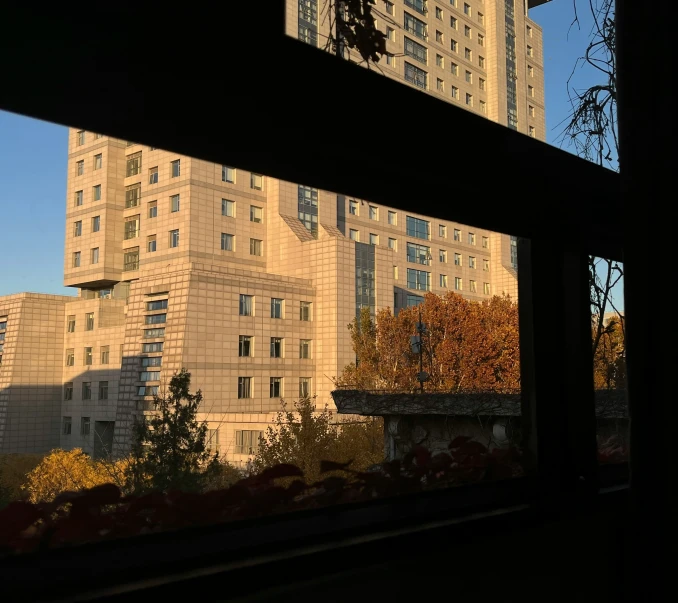 a building behind another large building looking out a window