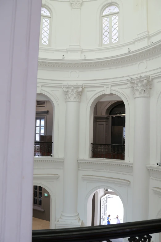 a tall white clock tower inside of a building