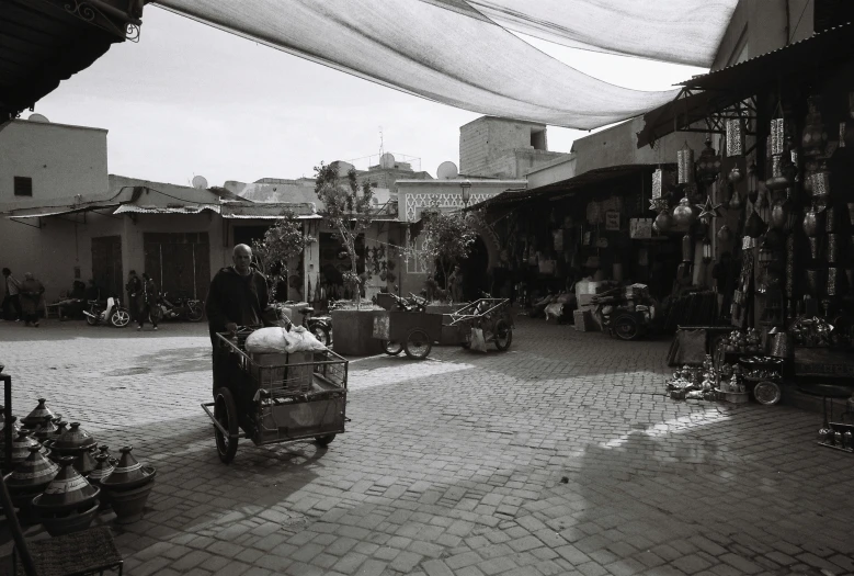 a market scene with a man walking through the market area