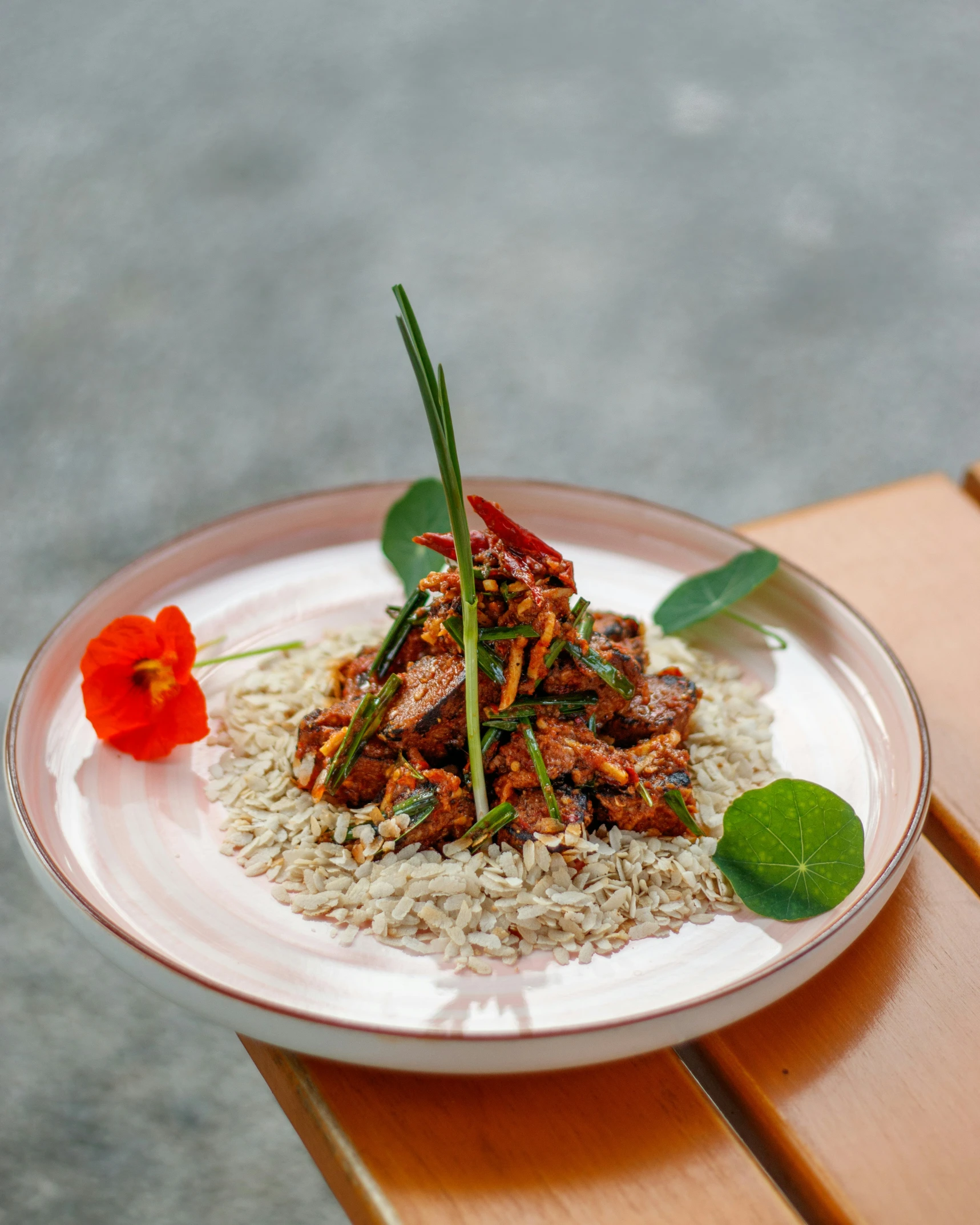 a plate with food, some flowers and water