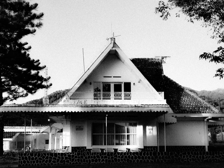 a small white house with an open roof and a porch