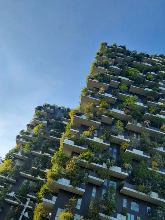 a tall building covered in green plants