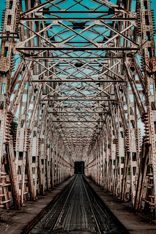 an old iron railroad bridge with tracks running through it