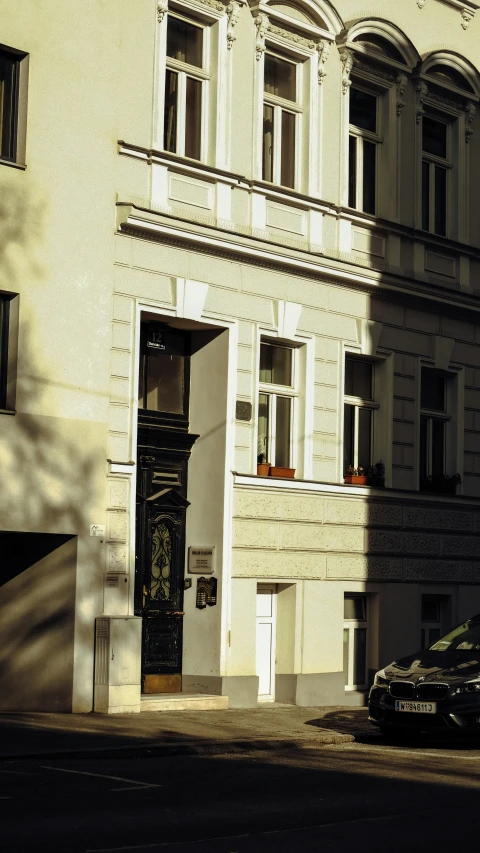 the side of an old building with cars parked outside