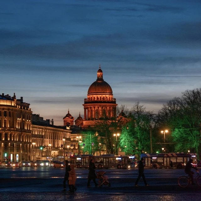 people walking around a city square near some buildings