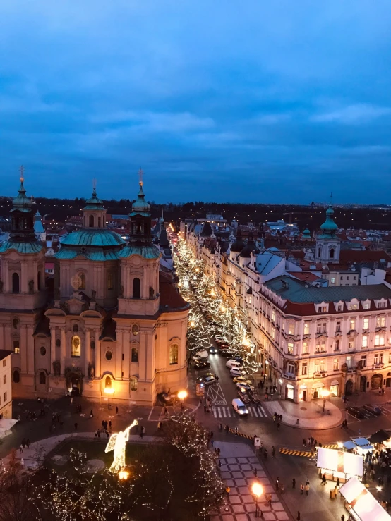 a couple of white buildings with christmas lights on them