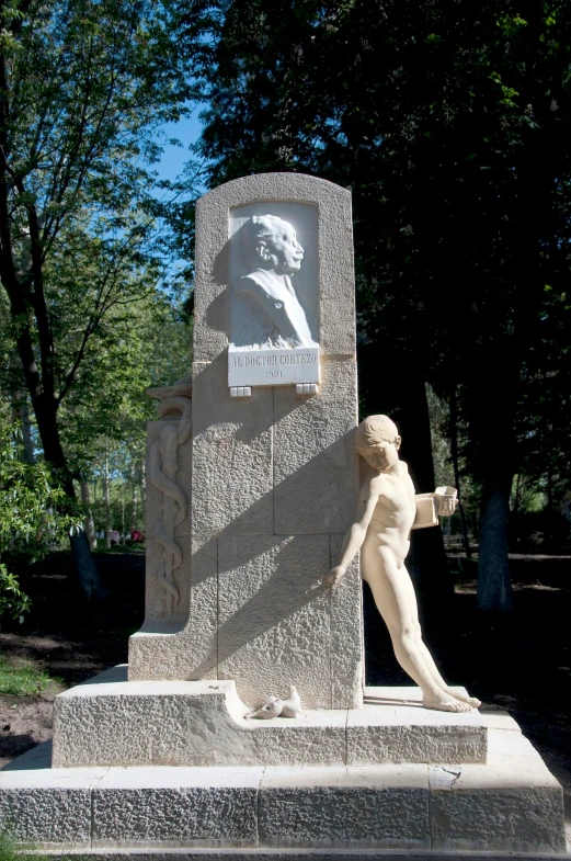 a statue of a female torso with a man pointing toward it