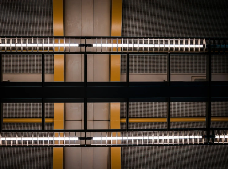 a wall that has four doors with yellow bars on it