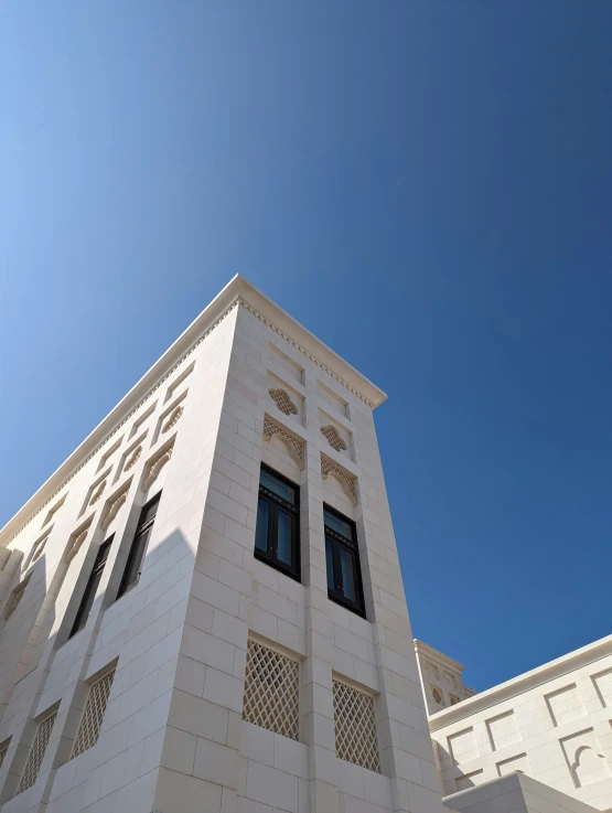 the top of a tall building under a bright blue sky