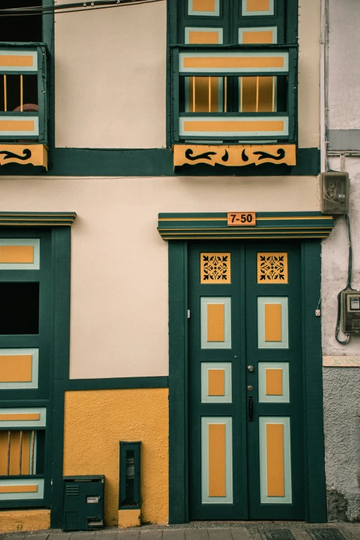 a po of a building with two green doores