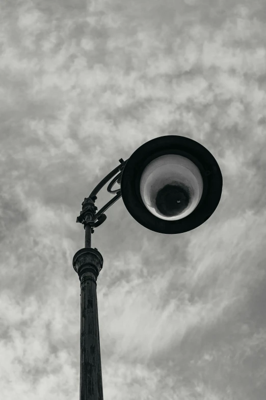 a lamp post and sky with clouds in background