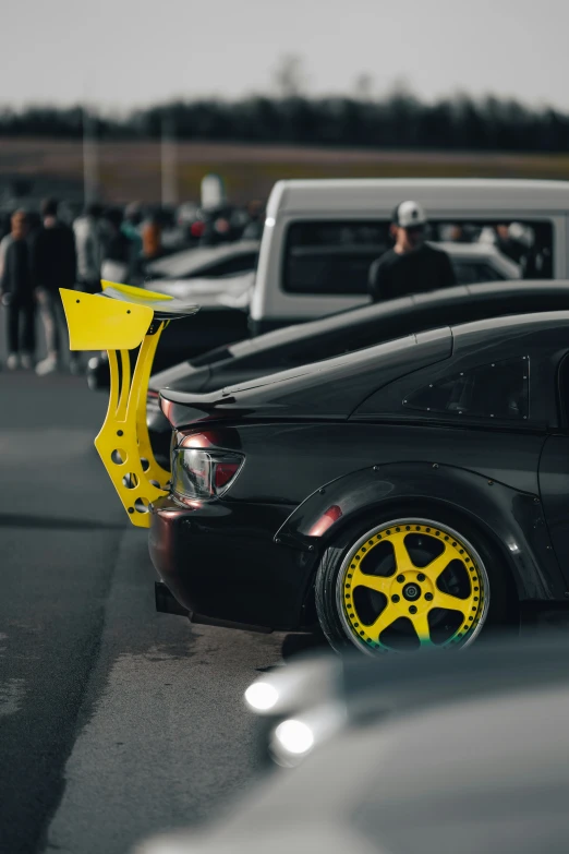 yellow accents on black car parked in a parking lot