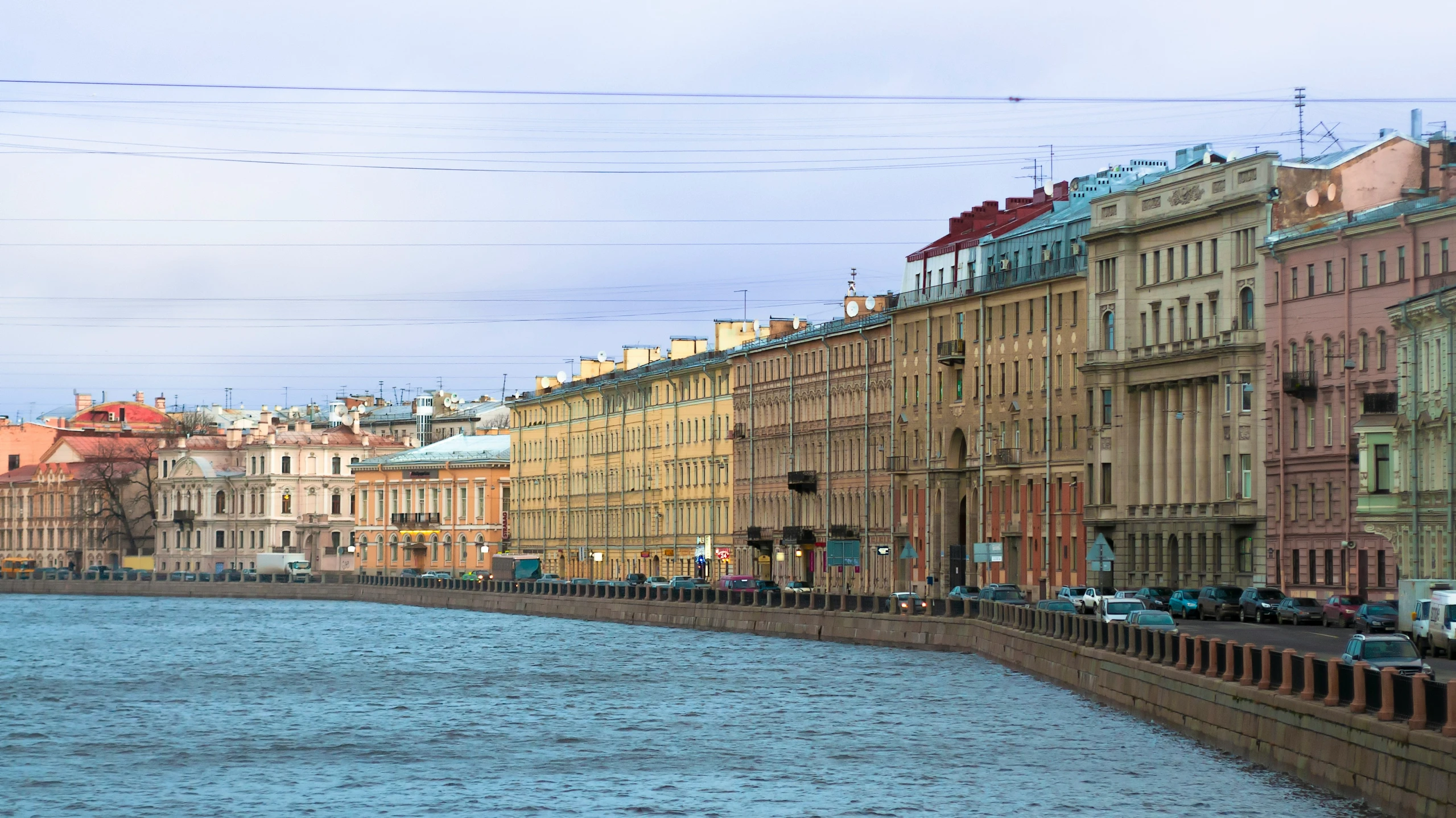 many buildings line the waterfront side of a body of water