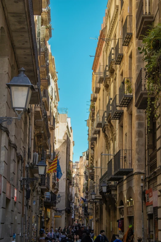 a city street filled with lots of people next to tall buildings