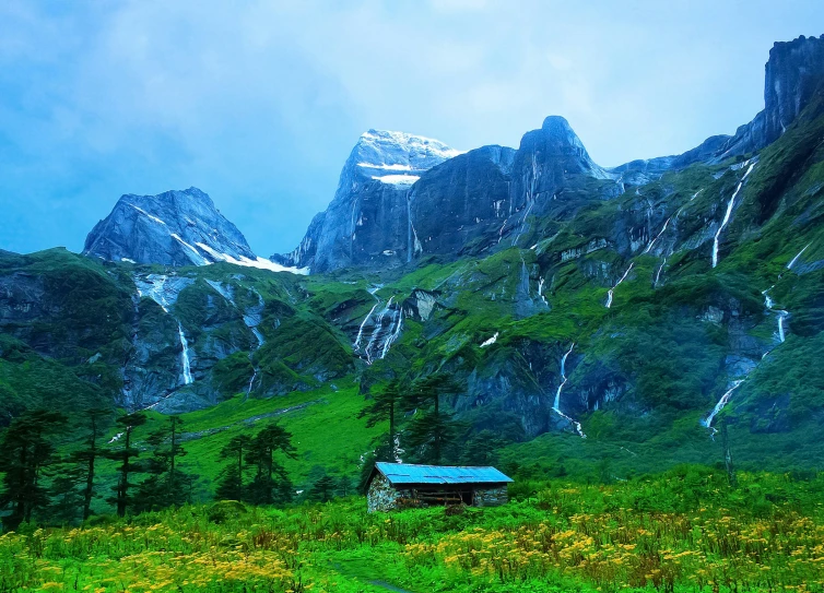 a cabin in a mountain with green mountains in the background