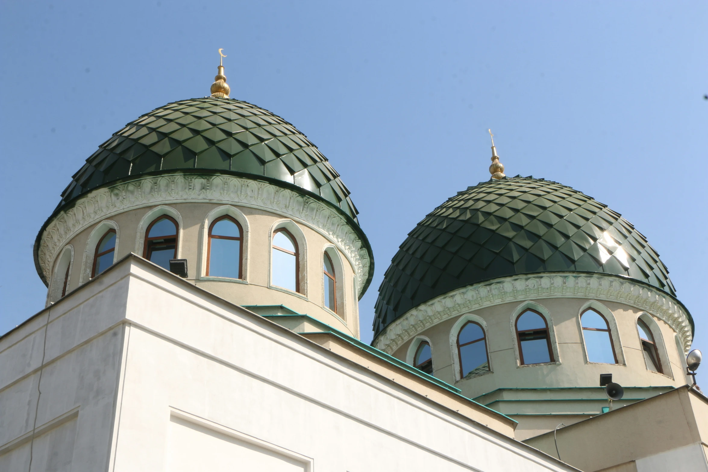 a white building with two very tall round buildings on top