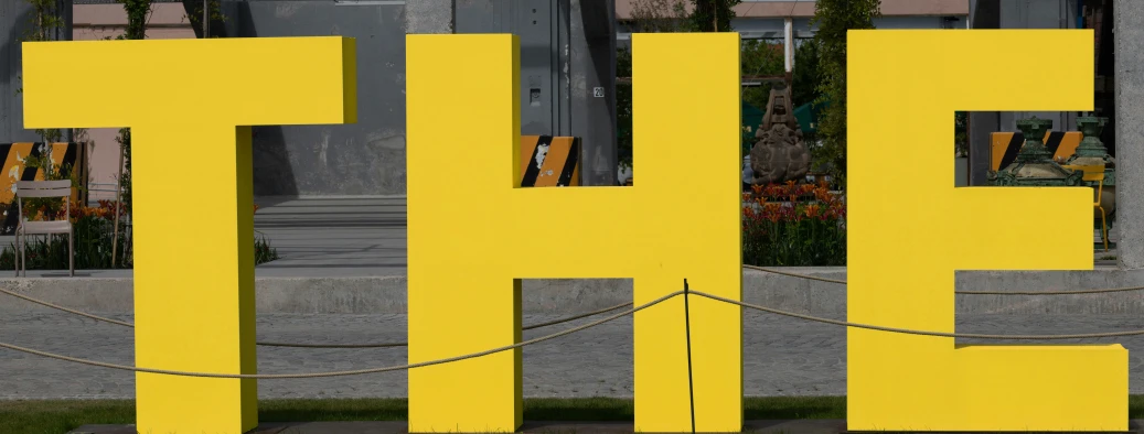 a yellow and black street sign in front of a building