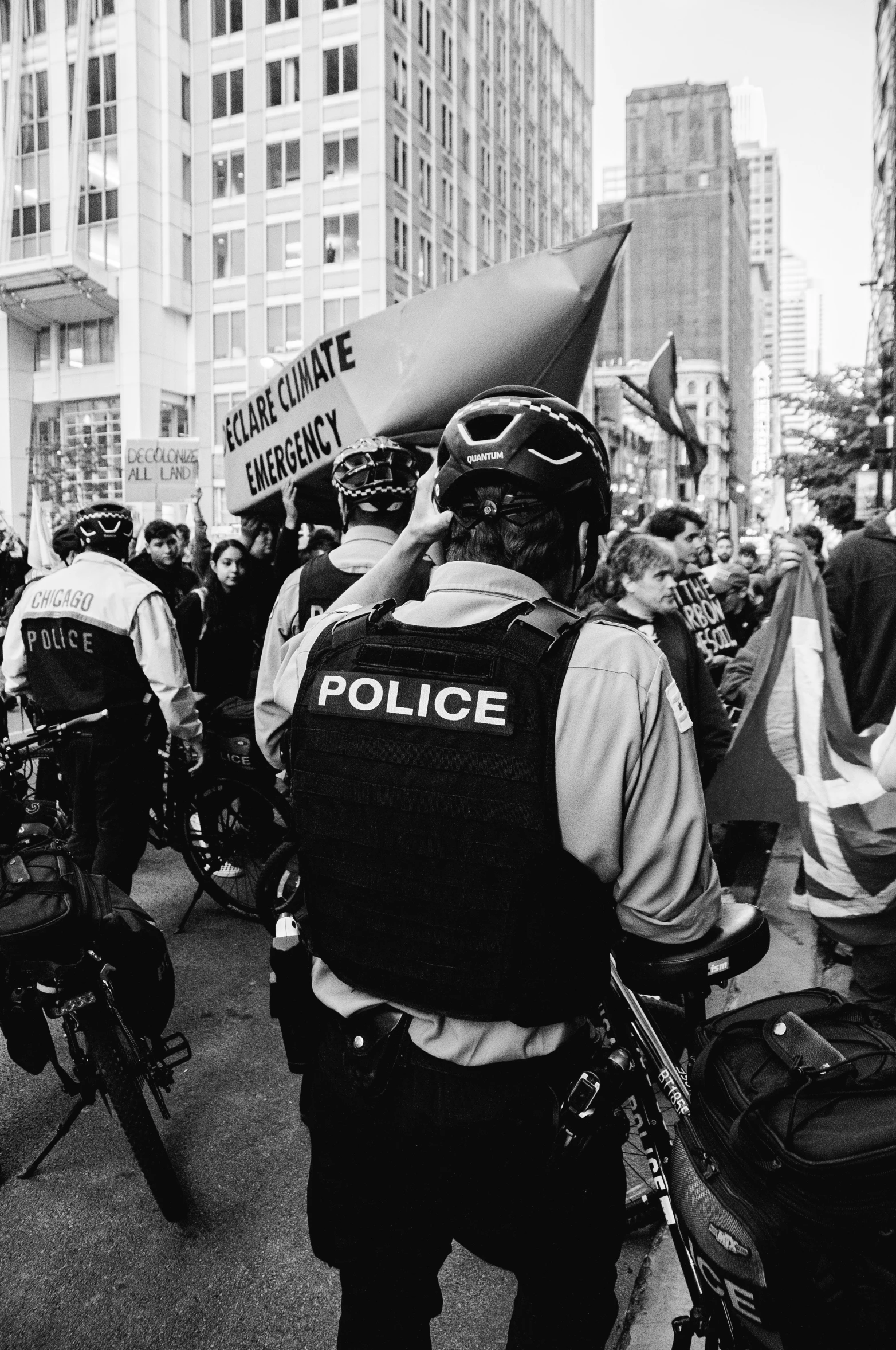 a large crowd of people on bicycles and some with signs