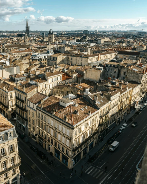 a city street with lots of buildings and tall towers