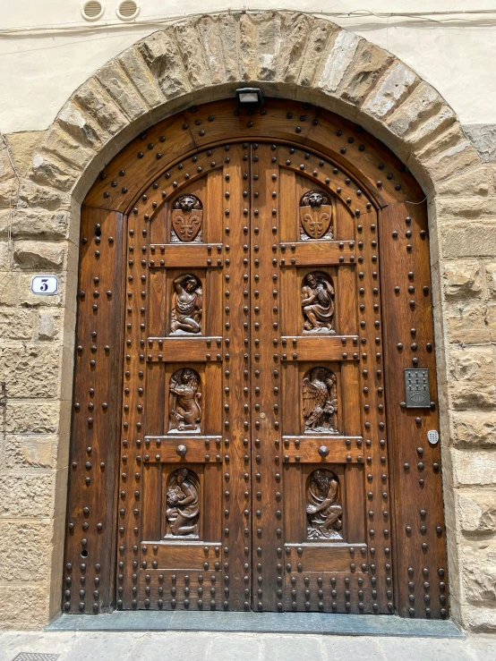 two large wooden doors on a stone wall