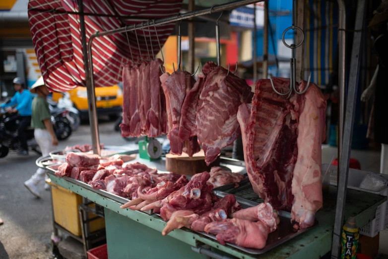 hams on a vendor table in an asian bazaar