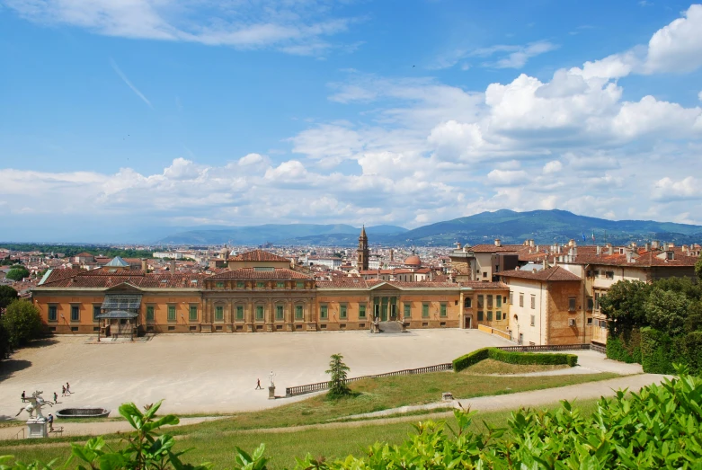 a large building sitting on top of a lush green field