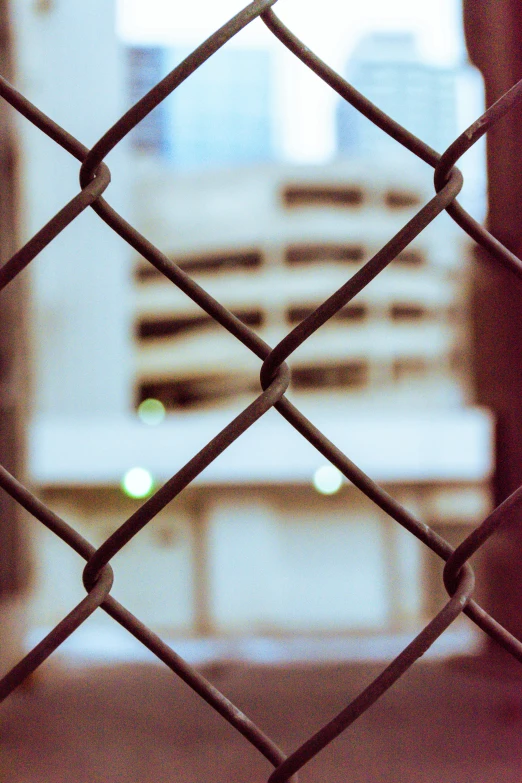 an image of the side of a building through a fence