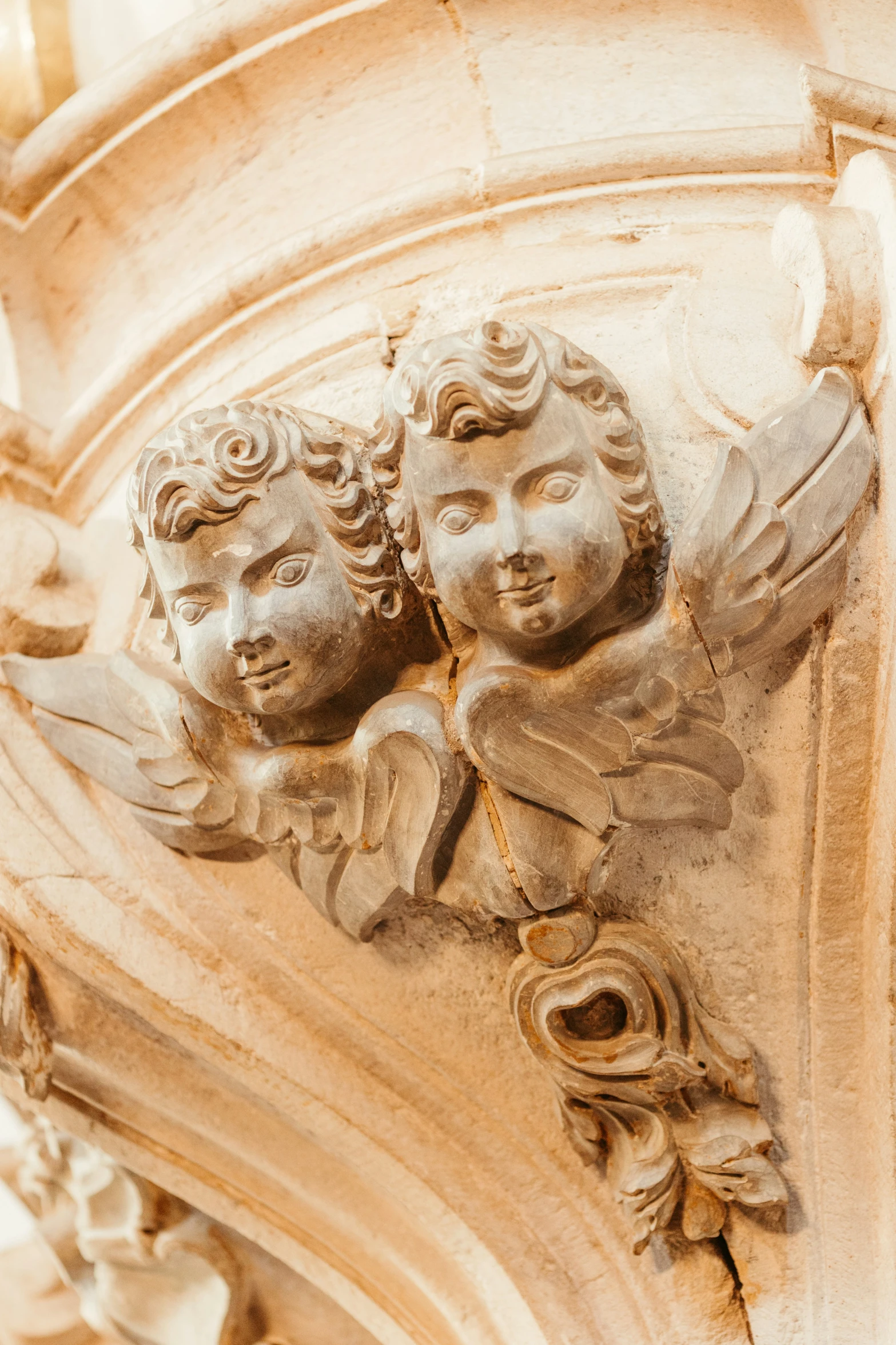 two cherubs, the center part of a carving of a building