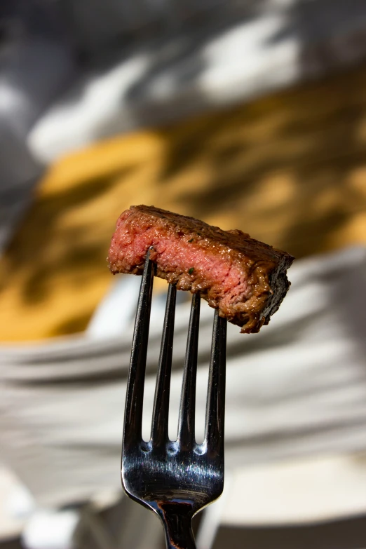 a piece of meat sitting on top of a fork
