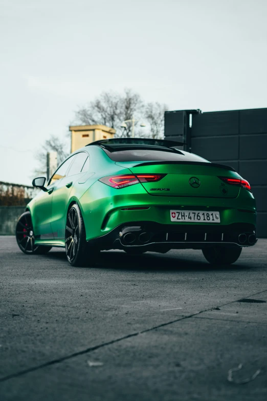 a green car parked on top of a street