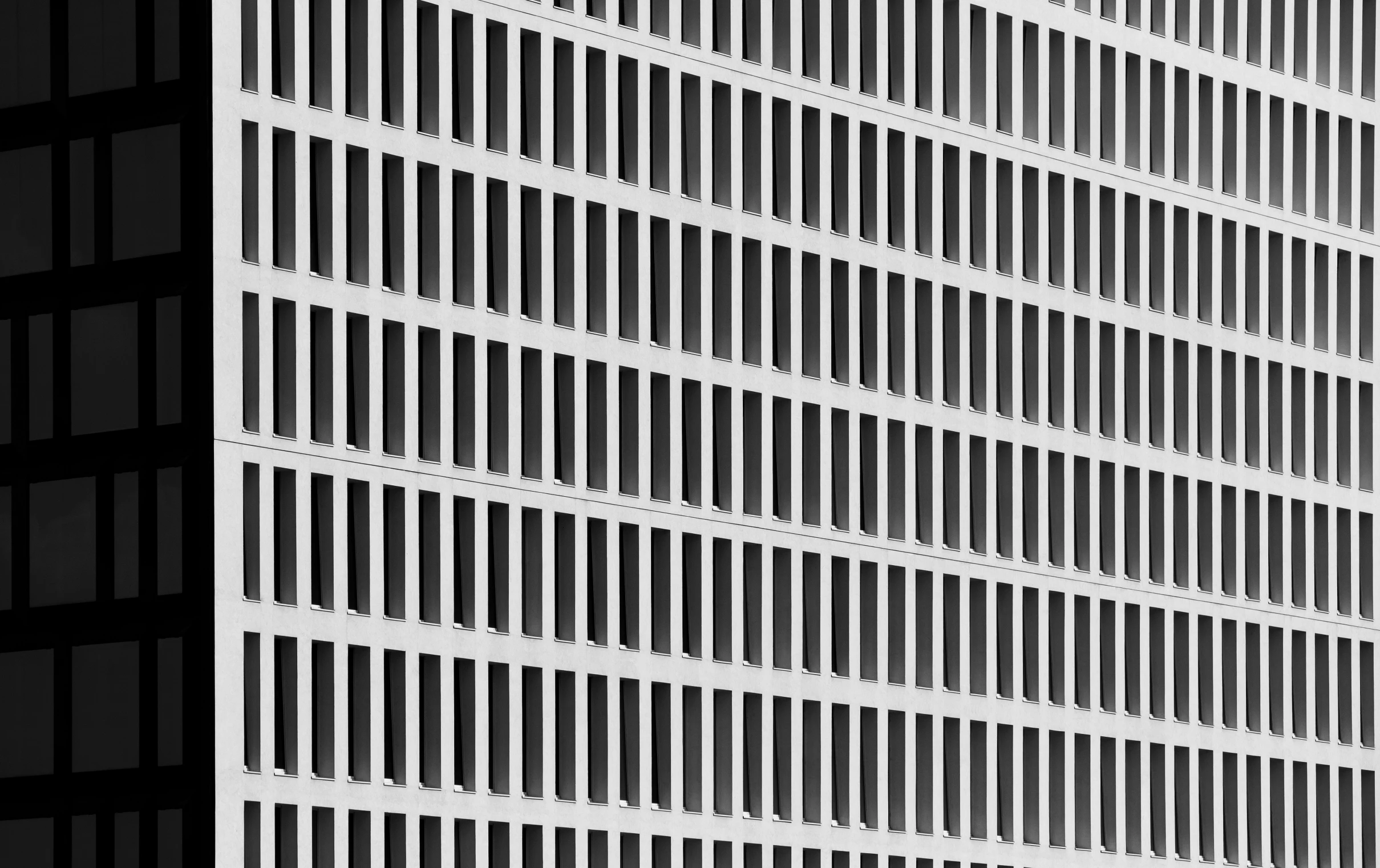 a bird flies near a building with tall buildings in the background